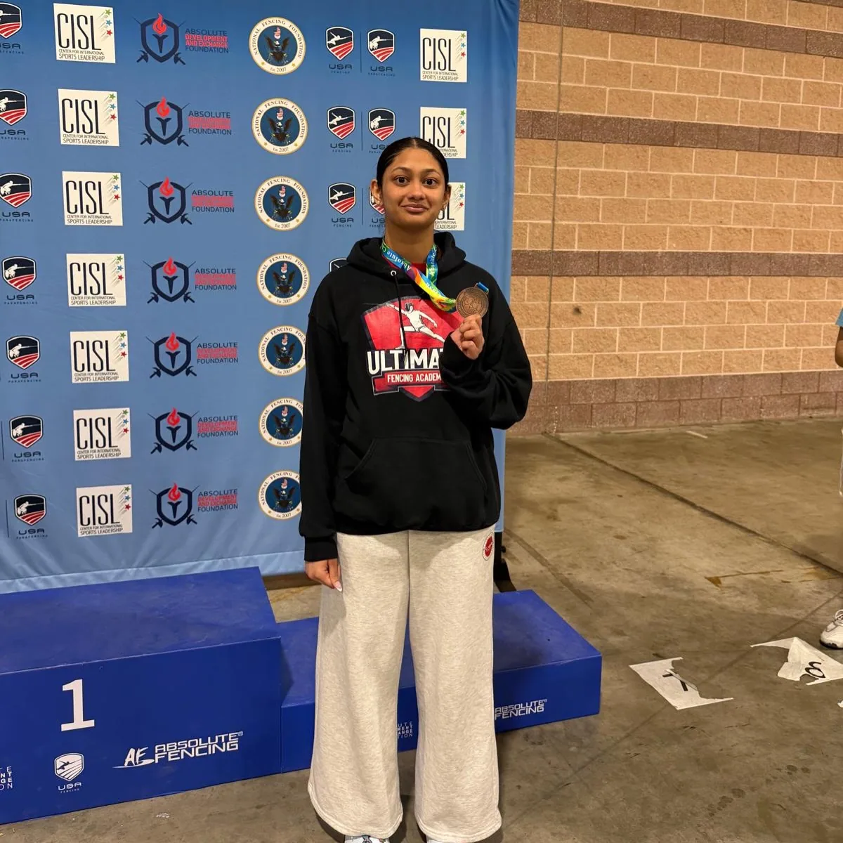 UFA student holding a bronze medal at the Absolute Fencing national championships