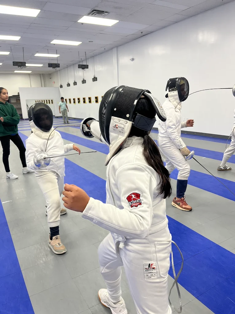 Students drilling blade actions in group class at Ultimate Fencing Academy