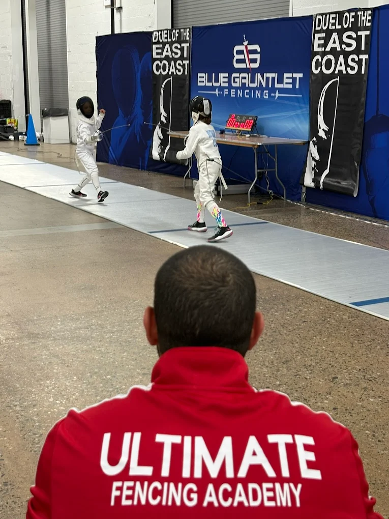 Coach Mahmoud working one-on-one with a student at Ultimate Fencing Academy