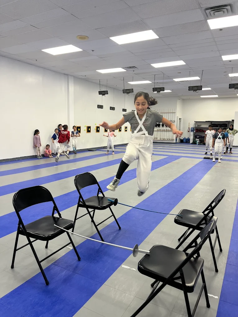 Camper jumping over blade in footwork exercise