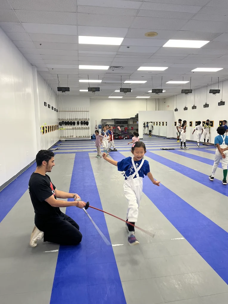 Coach teaching footwork one-on-one at camp