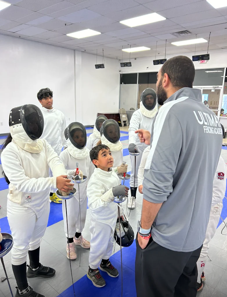 Coach briefing students before competition at Ultimate Fencing Academy